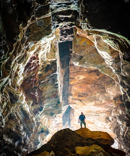 Preview: An explorer stands alone in a cave. Tiny humans big world