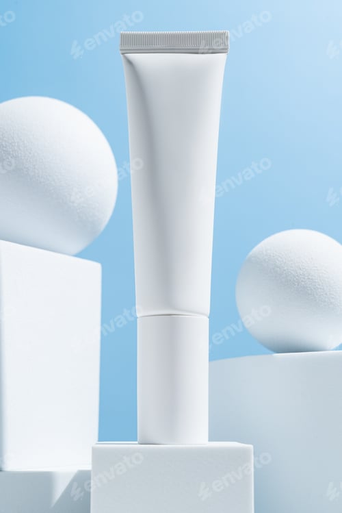 Preview: white cosmetic tube on a blue background on white cube podiums. The concept of a cream