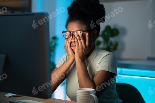Preview: Overworked african woman freelancer feeling eye strain and fatigue during prolonged computer use