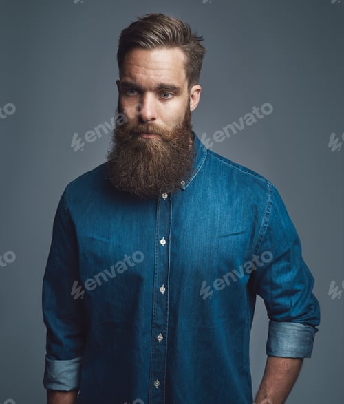 Preview: Bearded man in blue denim with serious expression