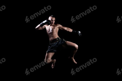 Preview: Thai Boxer In The Ring Hits With A Knee. The Concept Of Sports, Gyms, Boxing Clubs. Mixed Media