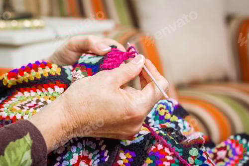 Preview: Hands Crafting a Colorful Crochet Project at Home