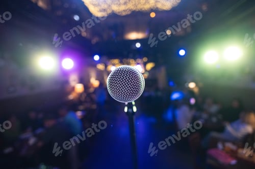 Preview: Microphone on stage against a background of auditorium.