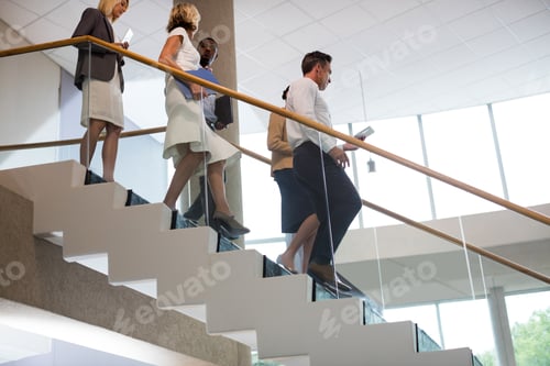 Preview: Business executives walking down the stairs