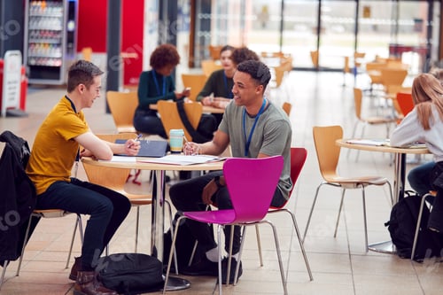 Preview: Communal Area Of Busy College Campus With Students Working At Tables