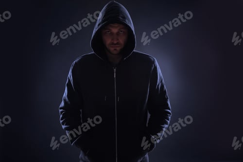 Preview: Mysterious man in hoodie on dark background. Dangerous criminal