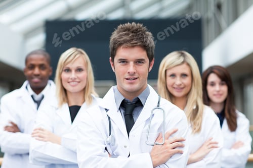 Preview: Handsome Young Doctor Leading His Team With Folded Arms