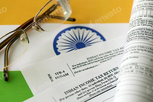 Preview: Indian income tax return blank form with pen and indian rupees bills
