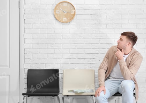 Preview: Young man waiting for job interview, indoors