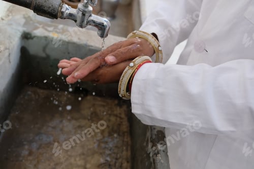 Preview: Closeup of an Indian female doctor washing her hands to prevent the spread of Covid-19