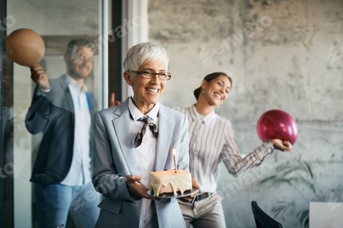 Preview: Group of happy business people surprising their colleague with Birthday party in the office.