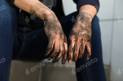 Preview: Dirty worker sitting on stairs, closeup of hands