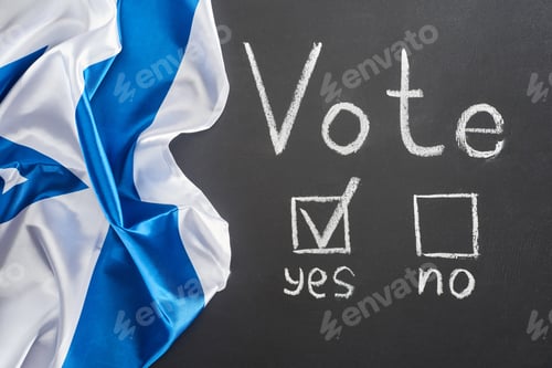 Preview: top view of vote lettering and check mark near yes word on black chalkboard near crumpled flag of