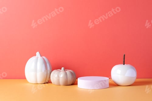 Preview: Empty product podium with Halloween pumpkin decor in pastel pink and orange colors