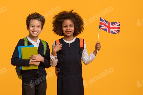 Preview: Smiling Schoolchildren Holding Books and a British Flag
