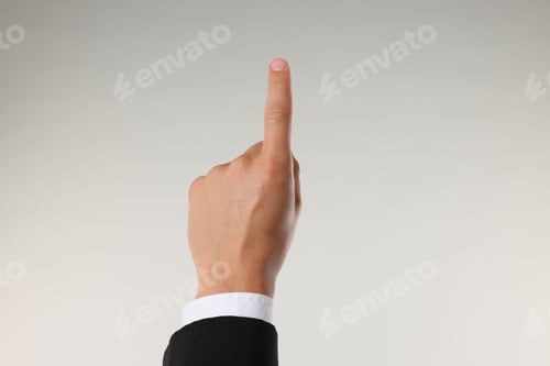Preview: Man touching something on light grey background, closeup