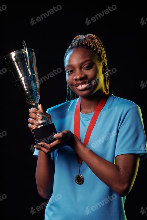 Preview: Female Black Athlete Holding Trophy Cup and Smiling