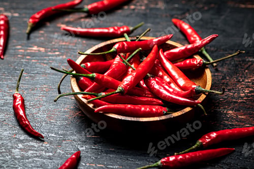 Preview: Wooden plate with hot chili peppers.