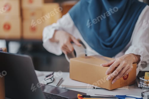 Preview: Small Startup Muslim Woman Checking parcels at work, freelancers, salespeople, checking production o