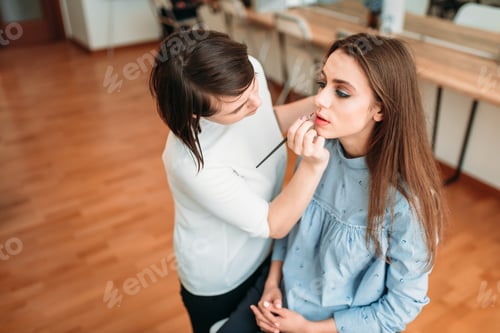 Woman Getting Makeup Applied by Makeup Artist