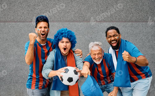 Preview: Group of passionate fans cheering for their team during soccer championship and looking at camera