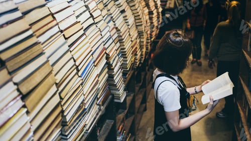 Preview: Woman is reading a book in the book store .