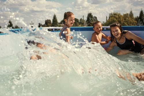 Preview: Children splashing, jumping, playing in a pool in backyard on summer vacation day