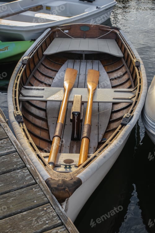 Preview: Vertical closeup of a wooden rowboat in harbor in New England
