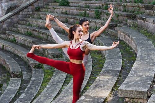 Preview: Content women doing yoga in Extended Standing Hand to Toe pose