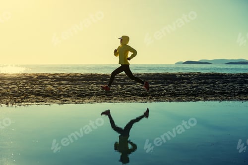 Preview: Woman trail runner cross country running in winter lakeside