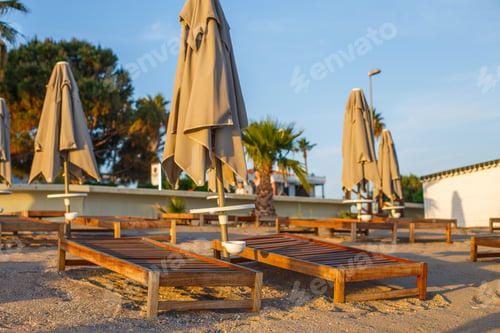Preview: beach scene in Side Turkey with empty umbrellas and sun loungers. Vacation at the sea.