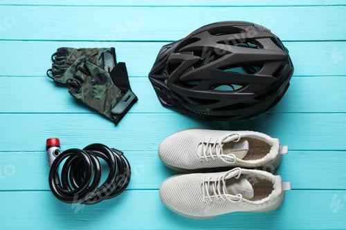 Preview: Flat lay composition with different cycling accessories on turquoise wooden background