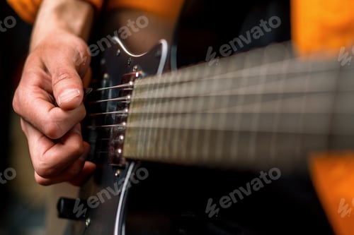 Preview: rock performer with electric guitar in recording studio recording playing track