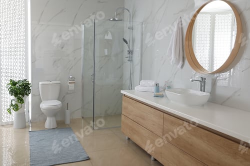 Preview: Toilet bowl near shower stall in modern bathroom