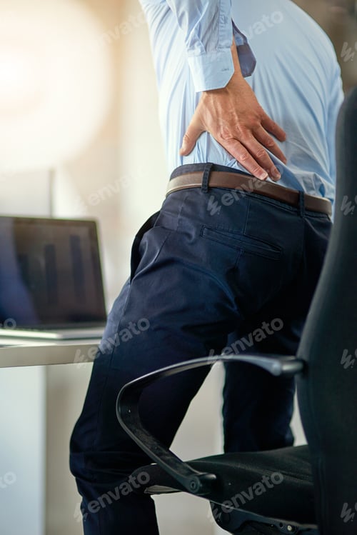 Preview: Strains and stresses of a tiring working day. Shot of a businessman suffering from back pain.