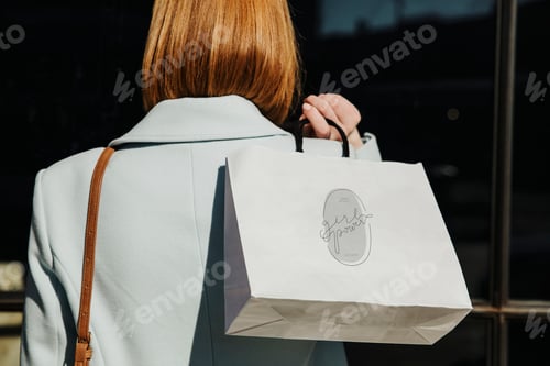 Preview: Woman carrying a minimal paper bag