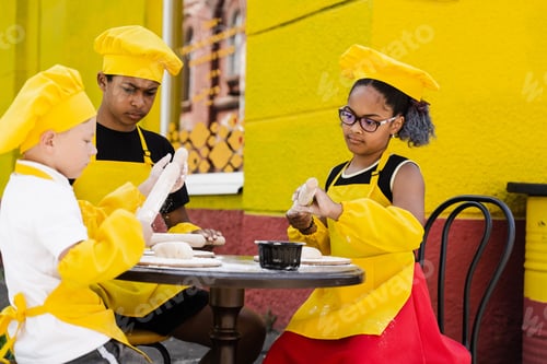 Preview: Happy multiethnic children enjoying shared cooking and dough making