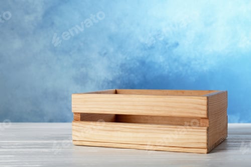 Preview: Wooden crate on table against color background. Space for text