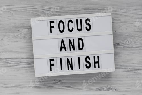 Preview: 'Focus and Finish' on a lightbox on a white wooden surface, top view. Flat lay, overhead, from above