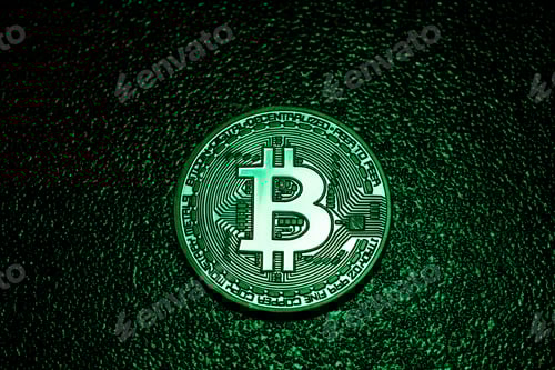 Preview: A coin with bitcoin logo in a green lighting.