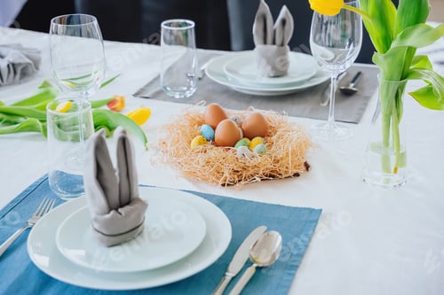 Preview: Beautiful Easter table setting with festive decor indoors,colorful eggs
