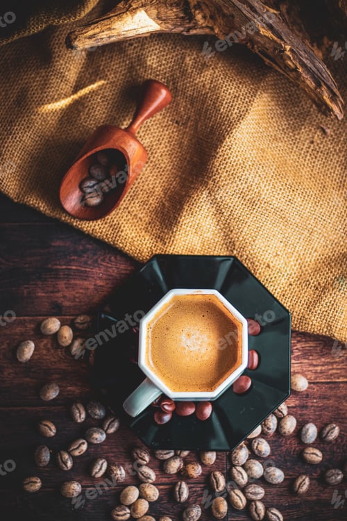 Preview: cup of freshly brewed coffee on a rustic wooden table with a spoon and coffee beans scattered around