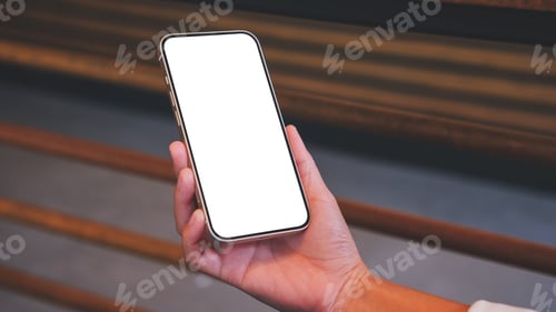 Preview: Mockup image of a woman holding mobile phone with blank desktop screen in cafe
