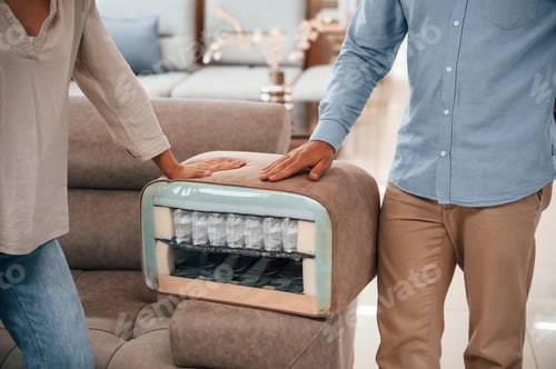 Preview: See what's inside. Couple choosing the sofa and bed in the store