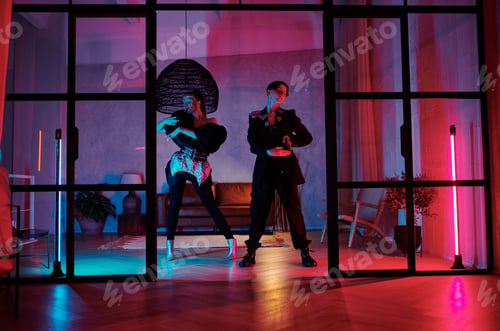 Preview: Two dynamic teenagers in posh attire performing vogue dance in loft studio