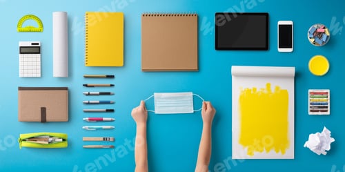 Preview: Flat lay top view of face mask and school supplies, back to school and coronavirus concept.