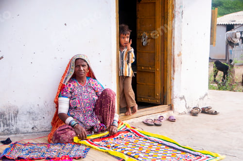 Preview: Tribal woman working her traditional handicrafts by embroidering colorful thread., india