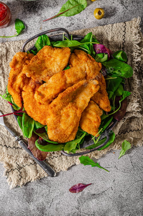Delicious Fried Chicken Cutlets Served with Fresh Greens