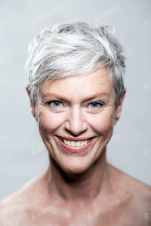 Preview: Portrait of laughing mature woman with short grey hair and blue eyes