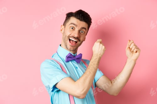 Preview: Image of cheerful man celebrating holiday, dancing and having fun, triumphing and saying yes with